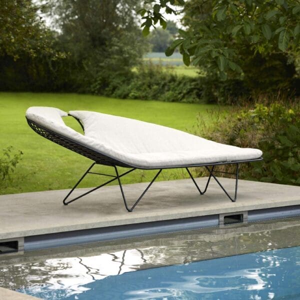 Image of Wire retro-inspired chaise longue by Joli, shown on poolside with lawn and trees in the background.
