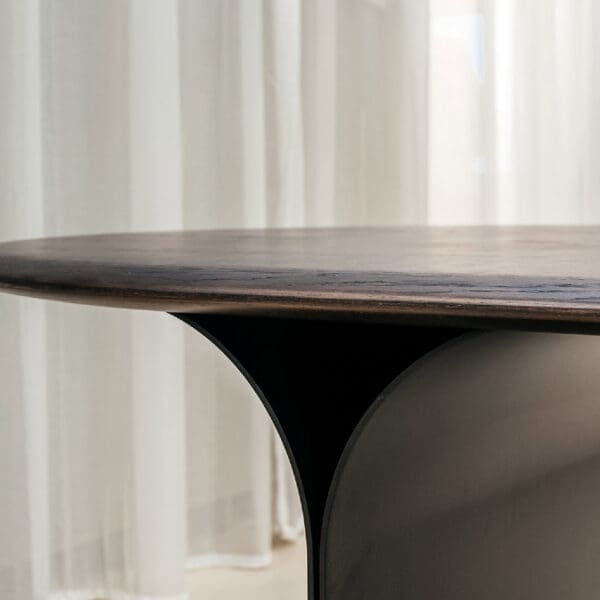 Image of detail of Arcs table's folded aluminium pedestal base and oval ceramic top by Joli furniture