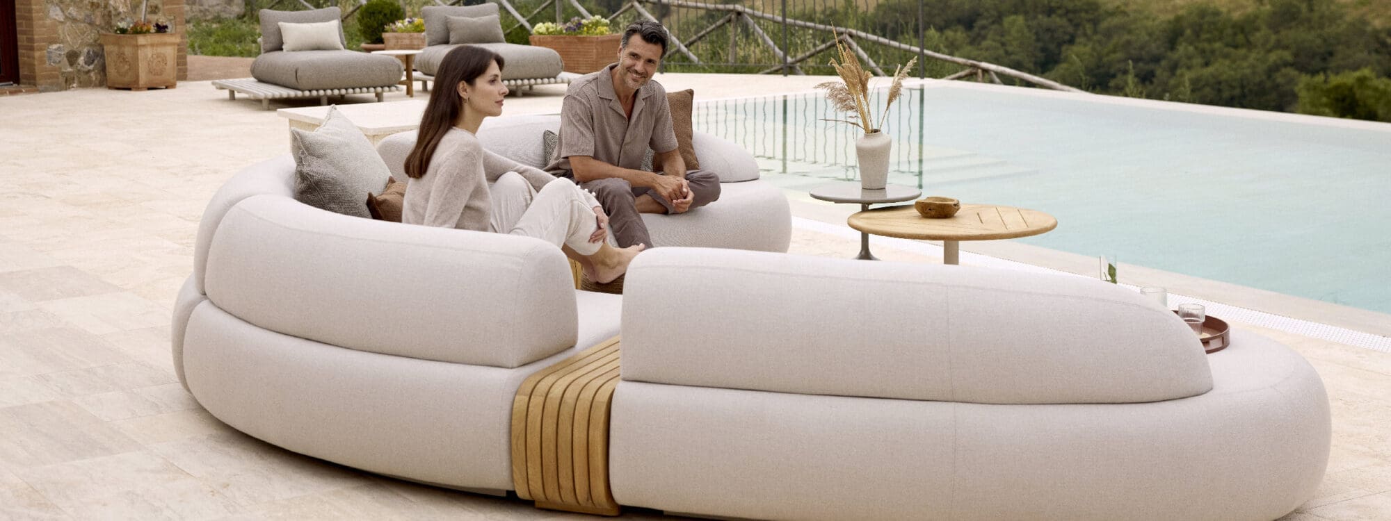 Image of couple relaxing on Cane-line Mellow garden sofa