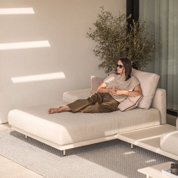 Image of woman relaxing on Todus Dongo chaise longue on shady patio