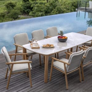 Image of Benoa ceramic garden table & teak dining chairs with swimming pool in the background