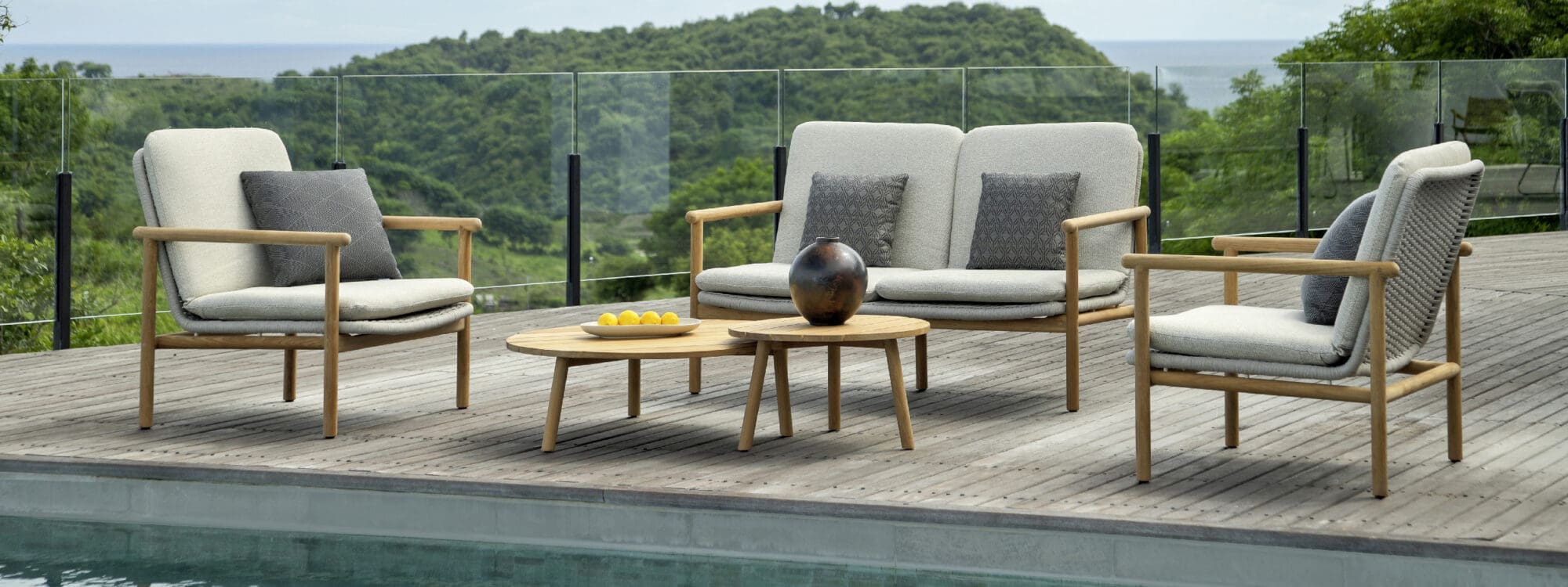 Image of Benoa 2 seat sofa and lounge chairs around Ronda circular coffee tables by Jati & Kebon