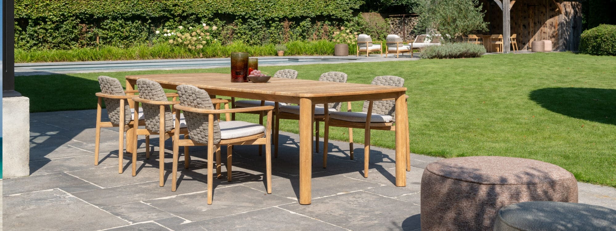 Image of Boho teak garden chair and Benoa luxury dining table on sunny terrace