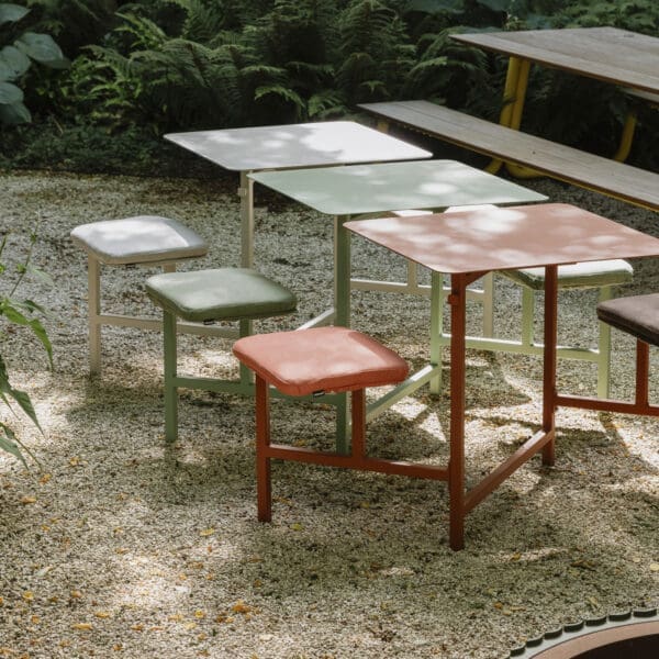 Image of 3 sets of The Duo small picnic tables in different colours, lined up next to one another