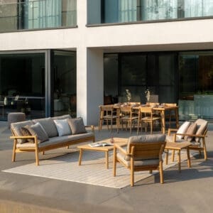 Image of Lynn teak sofa and lounge chairs, with Lynn teak dining set in the background