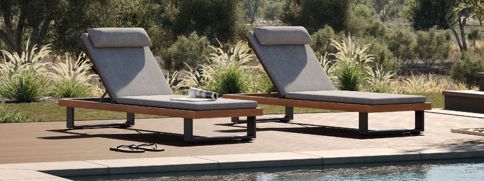 Image of pair of Truro modern sun loungers on poolside with grasses in the background