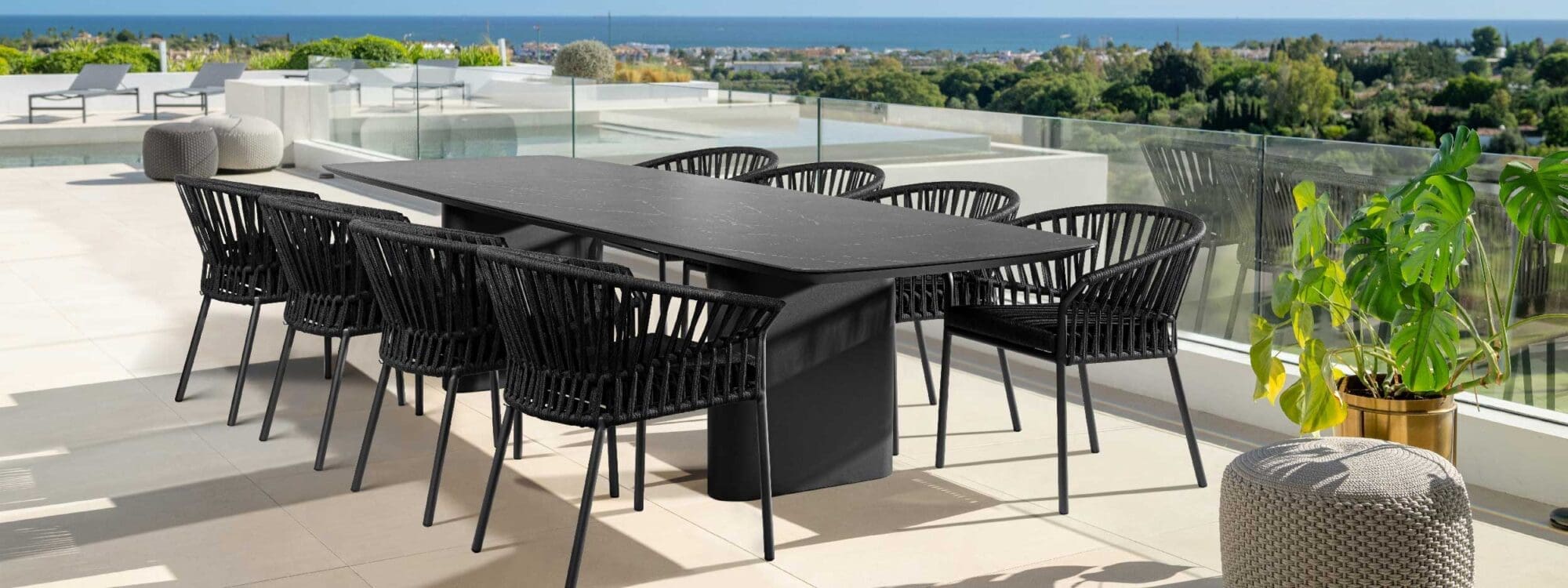 Image of charcoal black coloured Tofino aluminium garden chairs and Amorelli modern garden table by Jati & Kebon.
