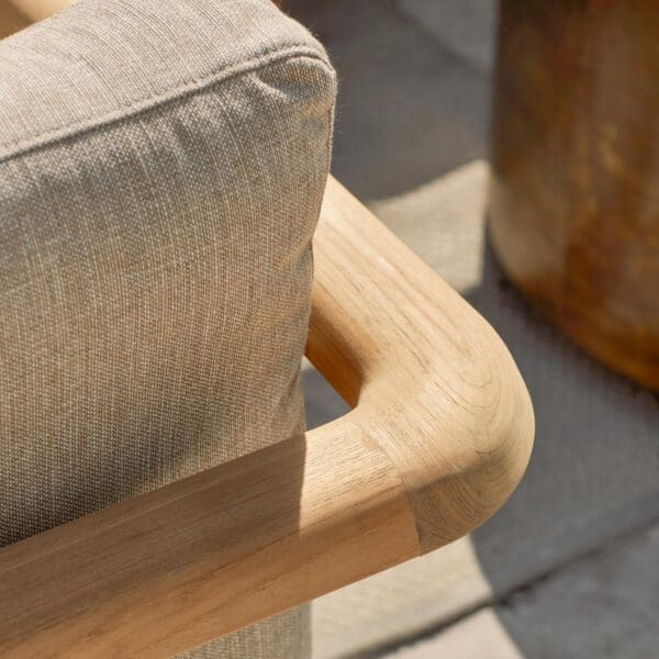 Image of detail of curved teak back and arm of Royal Botania Mambo Lounge teak sofa