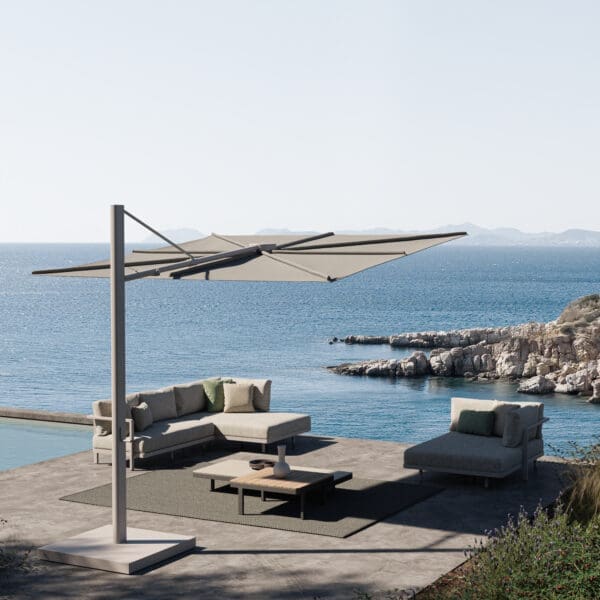 Image of Royal Botania Alura Lounge and Solaz parasol with blue sea and hazy sky in ther background