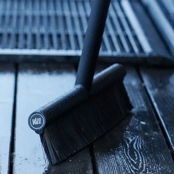 Image of RiZZ outdoor broom and outdoor brush on wet decking