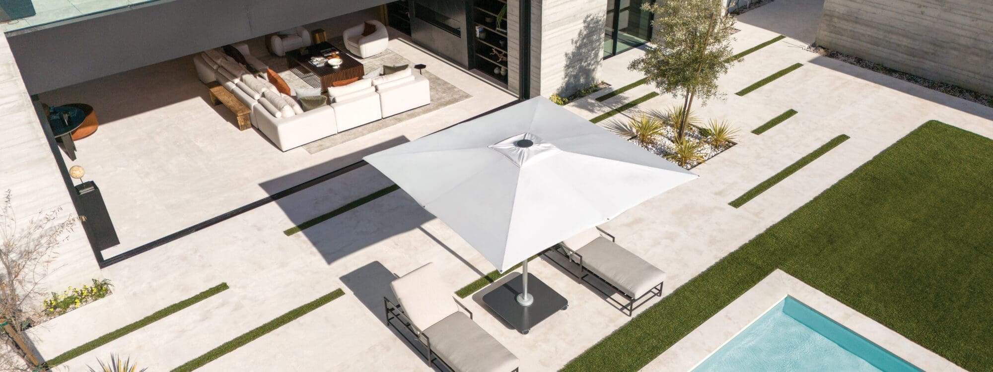 Image of pair of pair of Shademaker Atlas parasols on a sunny poolside