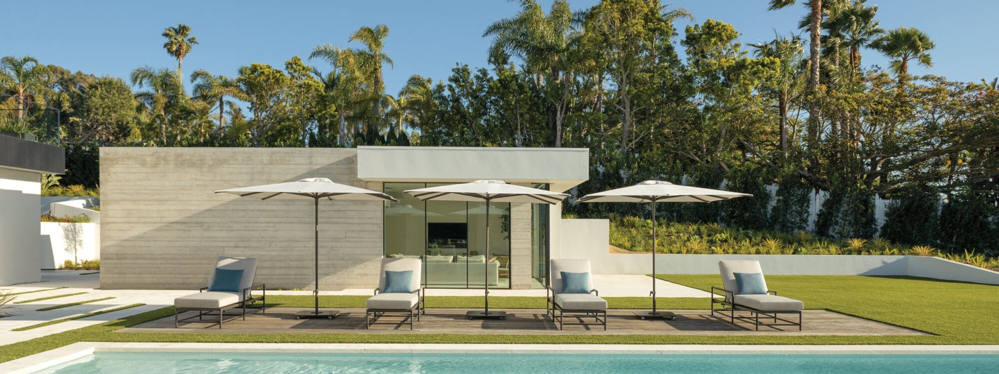 Image of row of Shademaker Libra parasols on sunny poolside