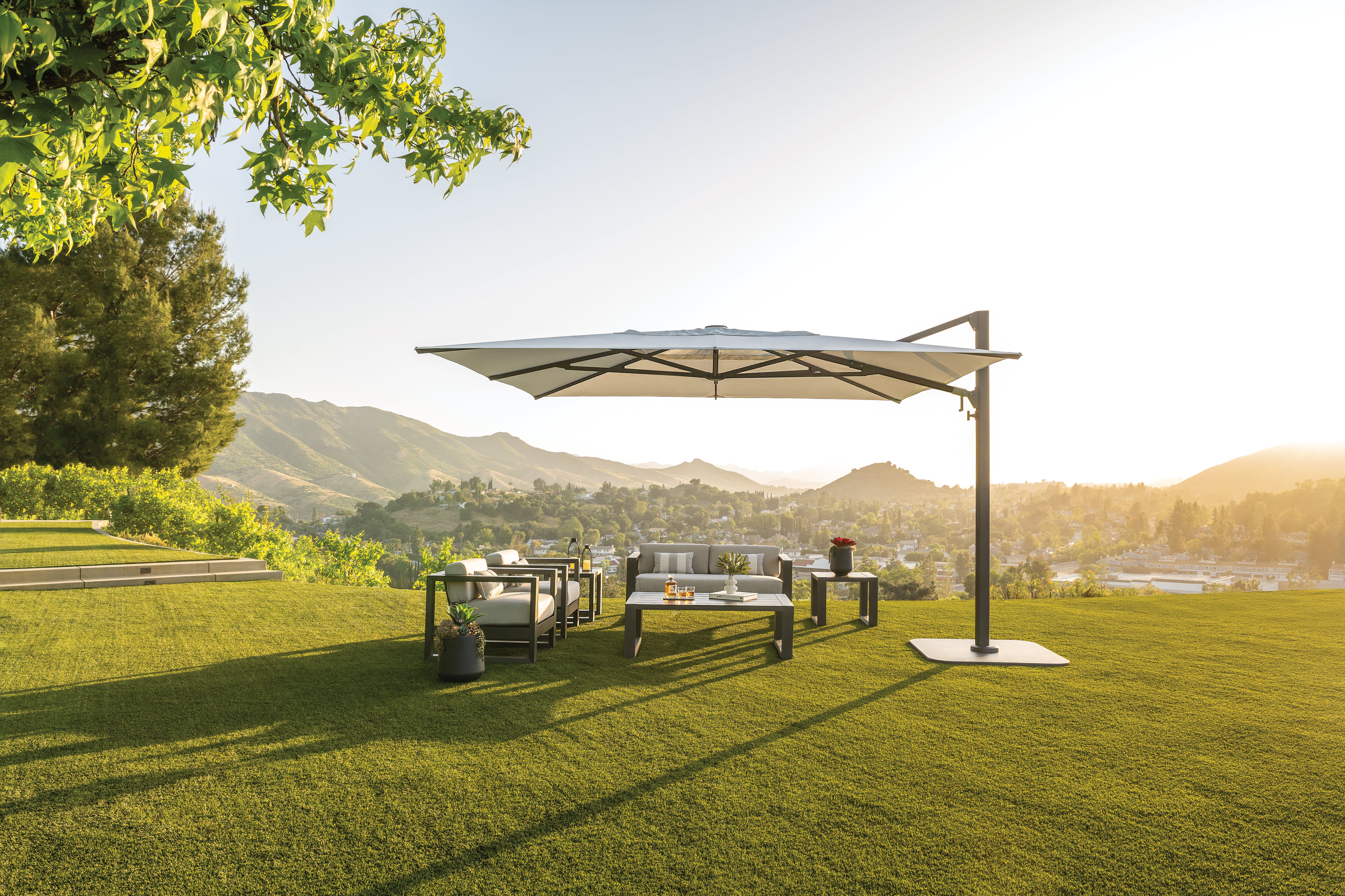 Image of Shademaker Polaris cantilever parasol casting long shadow on grass
