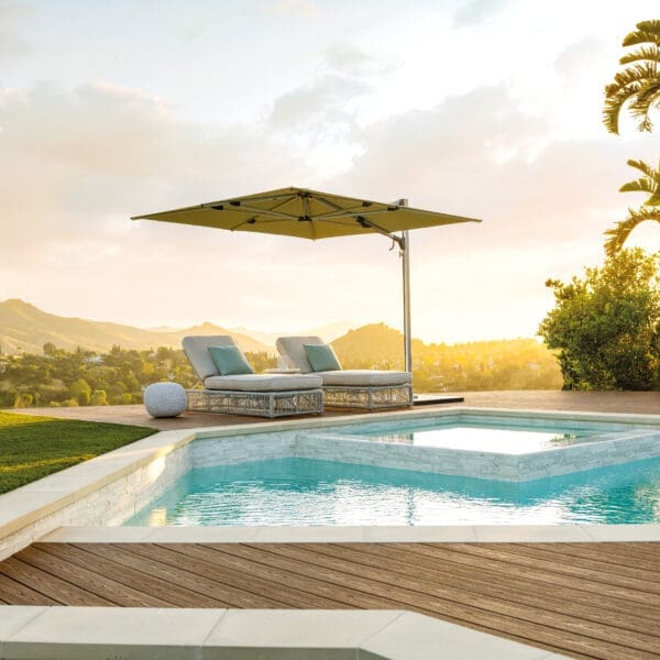 Image of Shademaker Solaris parasol at dusk with still waters of swimming pool in the foreground