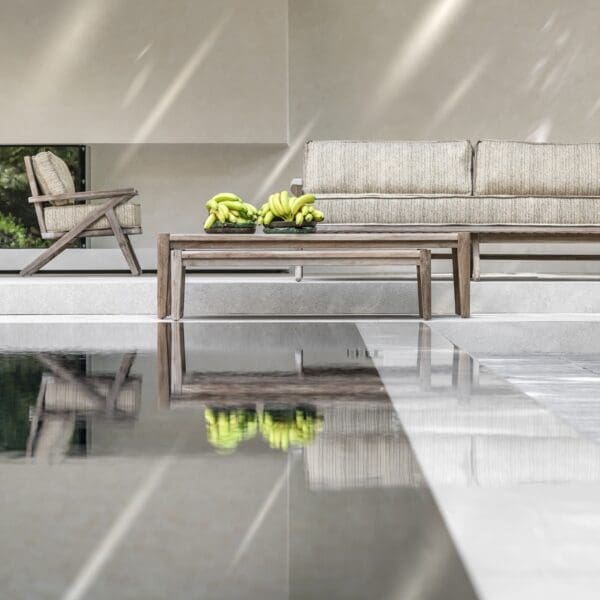 Image of Gommaire Alabama contemporary teak lounge furniture next to still waters of a swimming pool