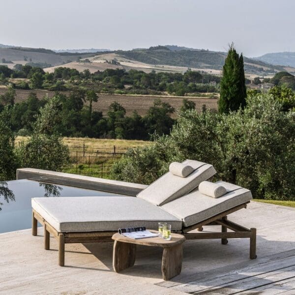 Image of Gommaire Mieke double sunlounger and Pebble teak side table on poolside with rolling Italian countryside in the background