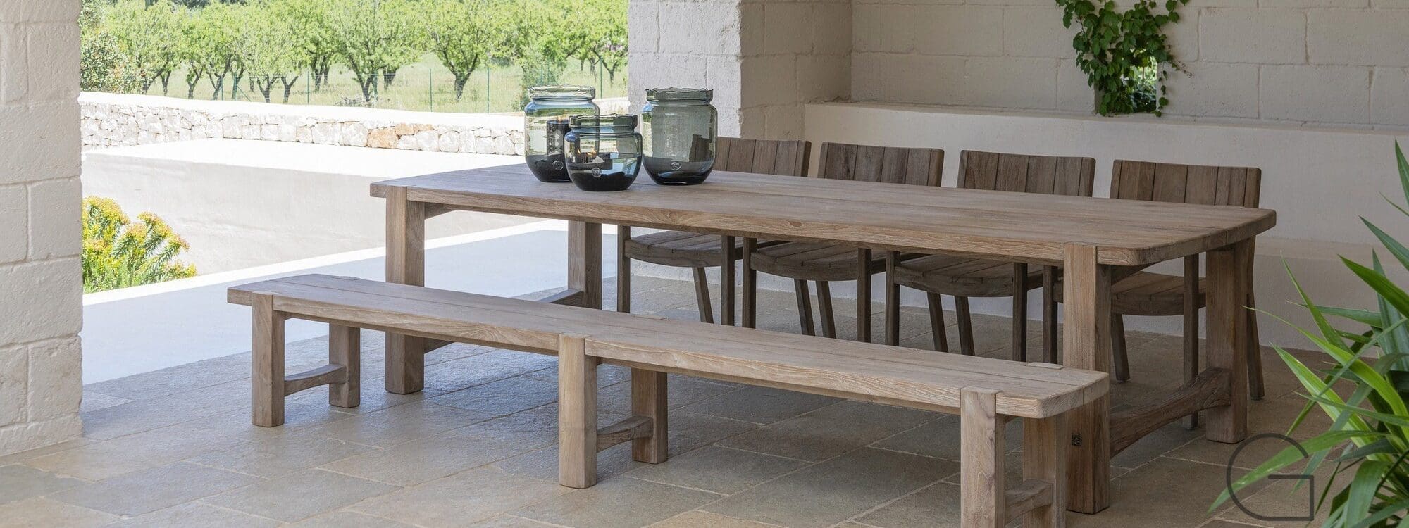 Image of Gommaire Jacoba teak garden table and bench on covered outdoor terrace