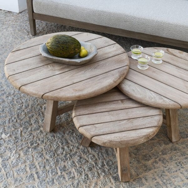 Image of the planked teak tops of Anton circular coffee tables by Gommaire