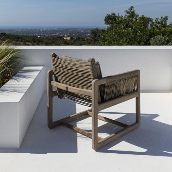 Image of Gommaire Carlo teak & rope easy chair on sunny whitewashed terrace