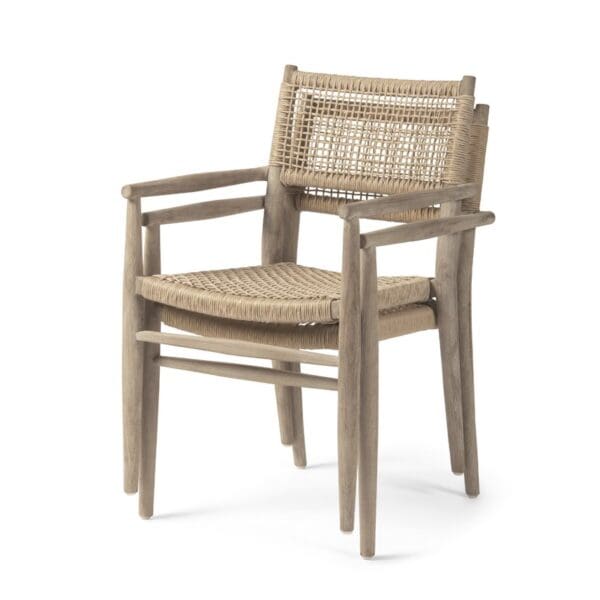 Studio image of a pair of Gommaire Mieke stacked teak garden dining chairs