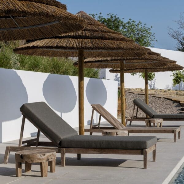 Image of row of Gommaire Copenhague Sunny teak daybeds along poolside