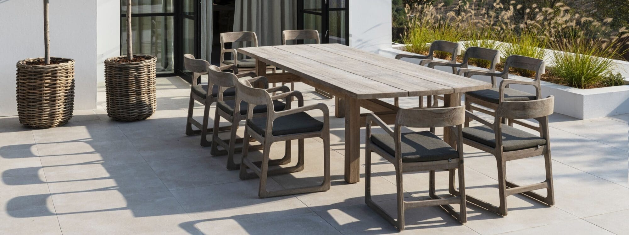 Image of Gommaire Abe rectangular teak table with 10 Sally teak dining chairs placed around the table