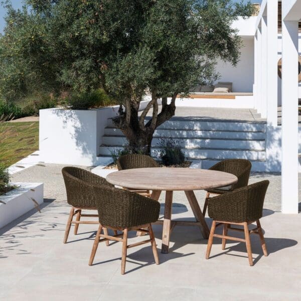 Image of Gommaire Anton round teak dining table on sunny terrace