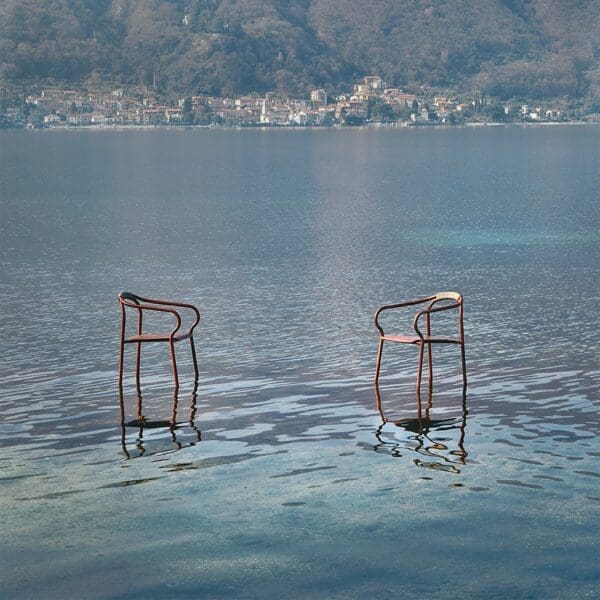 Image of pair of Salò modern garden chairs seemingly hovering about the waters of Italian lake