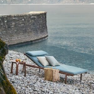 Image of Unopiu Salo luxury aluminium sunlounger in terracotta finish with blue cushion