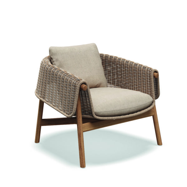 Studio image of Gloster Wrap lounge chair with sorrel wicker and teak frame