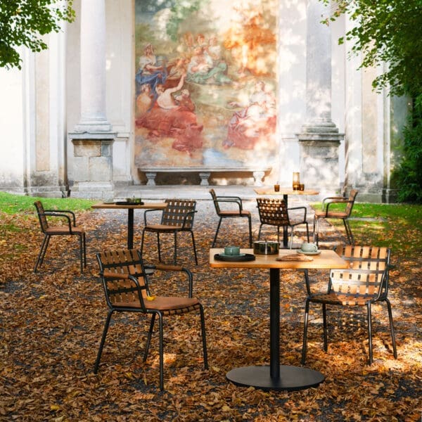 Image of Erice garden chairs and Button bistro tables amid fallen leaves on ground