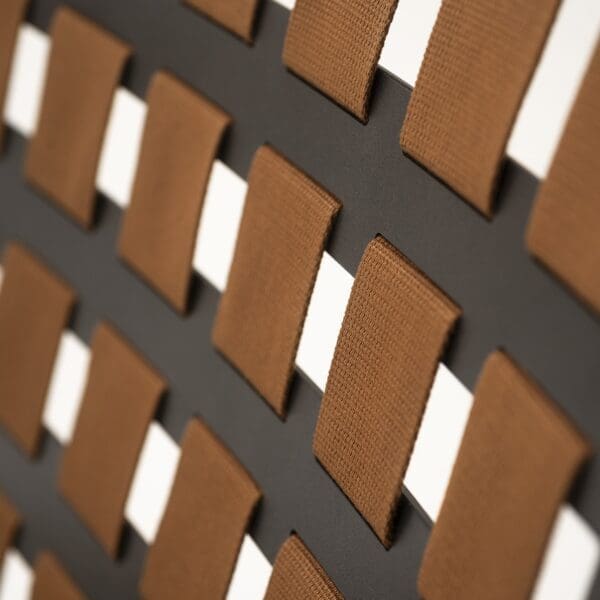 Image of detail of the acrylic belt woven within the holes of Erice garden chair's seat and back by RODA