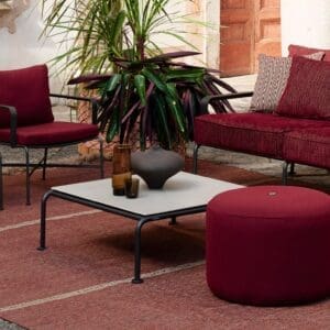 Image of RODA Stresa garden low table and pouf with Stresa garden sofa and lounge chairs in the background