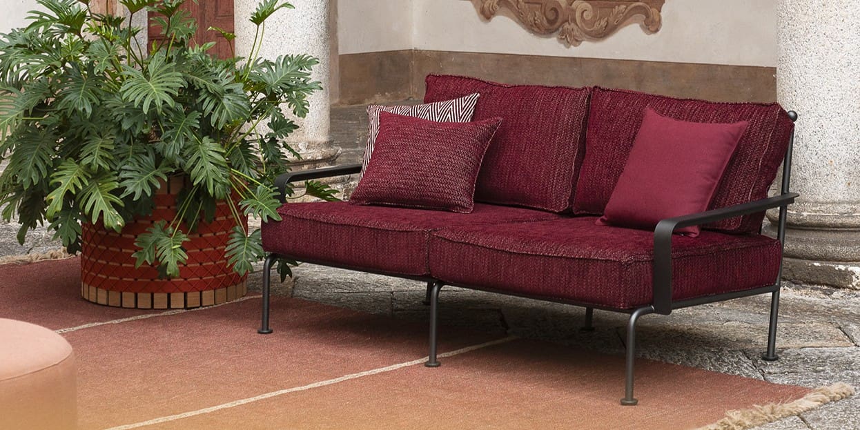 Image of Roda Stresa 2 seat garden sofa with voluptuous purple cushions