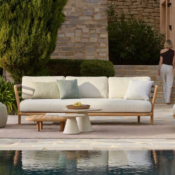Image of Royal Botania Archy 3 seater sofa refleccting in still waters of pool