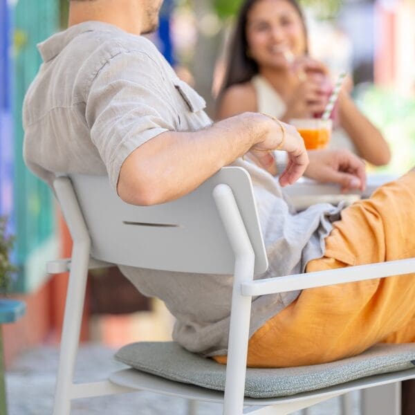 Image of man sitting back and relaxing in Lynsa aluminium armchair by Jati Kebon