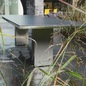 Image of FueraDentro Doble garden table with myscanthus in the forground