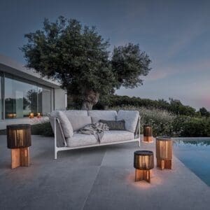 Image of Grand Sail 2 seat garden sofa at dusk by Gloster furniture
