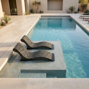 Image of pair of Lava basalt fibre sun loungers sat in chlorinated water of swimming pool