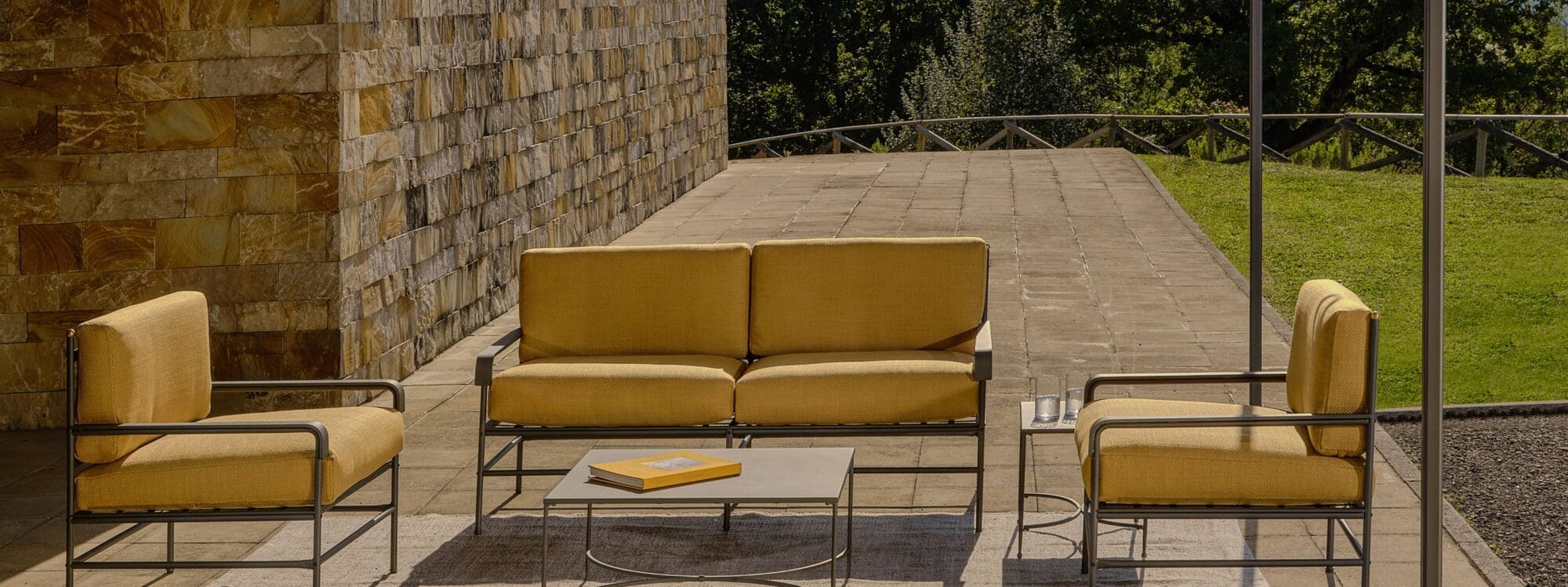 Image of Toscana traditional garden sofa and lounge chairs by Unopiu protected from blazing sun beneath a pergola