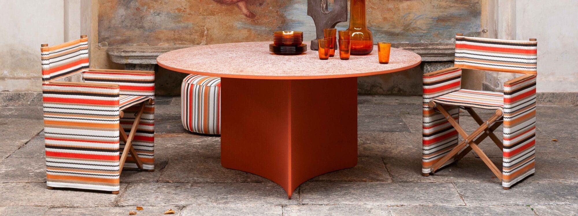 Image of Roda Orson chairs in Missoni fabrics together with Aspic table on orange concrete